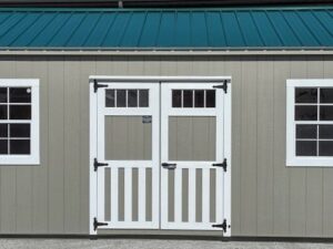 Model 10111 12 x 20 Clay with White Trim & Green Metal Roof A-Cottage