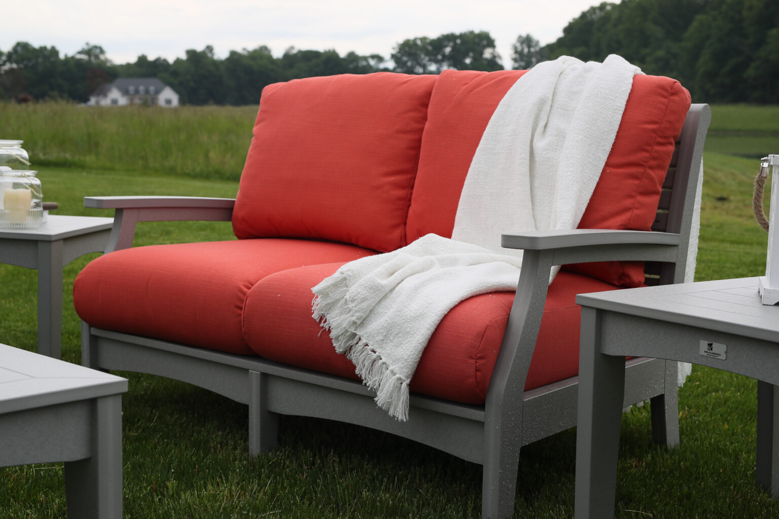 Berlin Gardens loveseat with orange red cushions