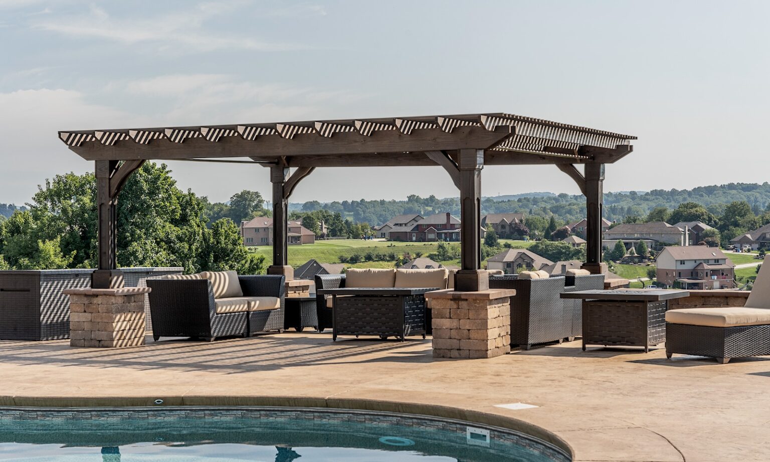 Outback Pergola in Mocha Stain. Grandfather Posts and braces wrapped with paver columns