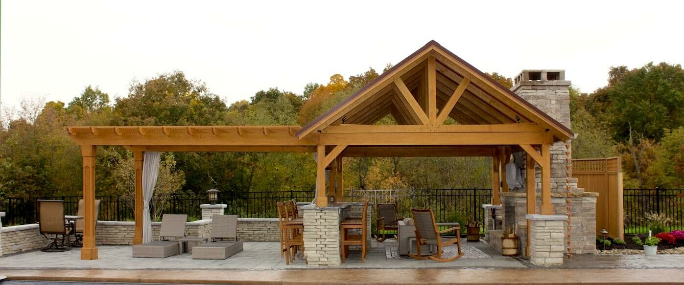 Stained Pavilion with a pergola connected to the side.