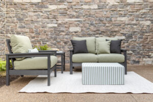 Camden Club Chair, and Camden Loveseat in Smoke Gray. Cushions in Heritage Leaf with throw pillows in Heritage Leaf and Heritage Char. Lumbar pillows and LilyHive Rectangular Pouf in Sail Away