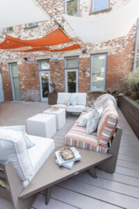 Holland Sofa, Loveseats, Angles Accessory Tables in Clay. 20x20 Lily Hive pofs