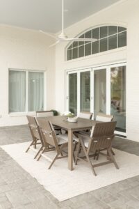 Kinsley Dining Chair and Kinsley Side Dining Chairs in Clay with cushions in Heritage Ashe. Shown around a 42” x 72” Expandable Berkley Table in Clay