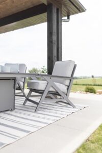 Kinsley Lounge Chair in Graphite with cushions in Canvas Granite. Shown with 8’ x 11’ Fig Rug