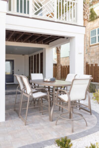 Murphy 42” x 76” Oblong Bar Table in Clay with Murphy Sling Bar Chairs and Murphy Bar Height Padded Sling Swivel Chairs in Clay, sling in Sailing Salt. (2)