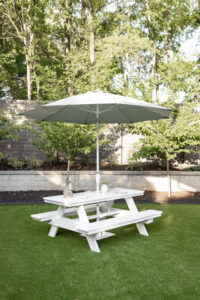 Rectangular Picnic Table in White. Umbrella in Cast Oasis